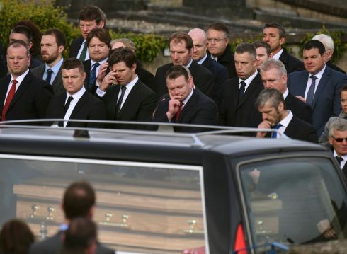 Former Ireland captain Brian O'Driscoll (2nd left) watches as the coffin of Munster rugby coach Anthony Foley arrives at St Flannan's Church for his funeral service in Killaloe. Photorgraph: Clodagh Kilcoyne/Reuters
