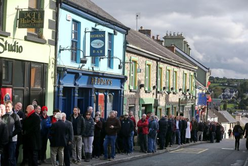 People wait in line to view the coffin of Munster head coach Anthony Foley in repose in St Flannan's Church, Killaloe, Co Clare on Thursday. Photograph: Niall Carson/PA Wire