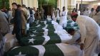 Pakistani mourners with  the coffins of some of those killed in an attack on the Police Training College in Baluchistan, Quetta. Photograph: Banaras Khan/AFP/Getty Images