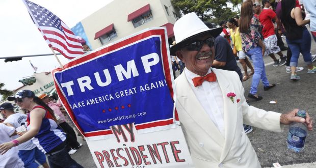 Santiago Portal, who migrated from Cuba 50 years ago, displaying a sign supporting Donald Trump in Little Havana during the Calle Ocho Festival, Miami, last March. Photograph:  Sean Drakes/Getty Images