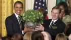 US  president Barack Obama  receives a bowl of shamrock from Taoiseach Enda Kenny at the  St Patrick’s Day reception at the White House in Washington. Photograph: Chris Kleponis/Reuters 