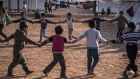 Children play at the Khazer camp for people displaced by the fighting around Mosul. Photograph: Sergey Ponomarev/New York Times 