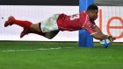 Tonga’s Siale Piutau scores a try against Italy. Photo: Getty Images