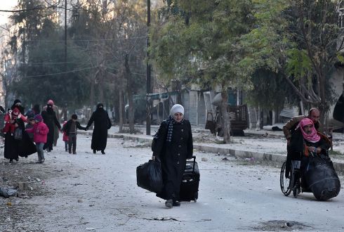 ALEPPO: Syrian residents fleeing the violence in the eastern rebel-held parts of Aleppo evacuate from their neighbourhoods through the Bab al-Hadid district after it was seized by government forces. Photograph: George Ourfalian/AFP/Getty Images
