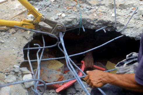 INDONESIA QUAKE: The hand of an earthquake survivor is seen under rubble as residents try to rescue him in Pidie Jaya, Aceh province, Indonesia. Dozens of people died as a result of the quake. Photograph: Aqien Abdullah/AFP/Getty Images
