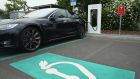 A Tesla electric-powered sedan  at a  charging station in Germany. Photograph: Sean Gallup/Getty Images