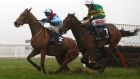 Unowhatimeanharry ridden by Barry Geraghty (right) clears the last flight in company with Ballyoptic ridden by Richard Johnson before going on to win The JLT Long Walk Hurdle Race  at Ascot. Photograph:   Julian Herbert/PA Wire