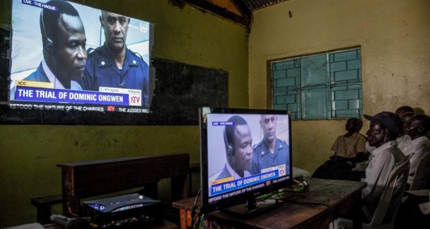 People watch on TV the screening of the start of the ICC  trial of former Lord’s Resistance Army commander Dominic Ongwen who is facing  charges of war crimes and crimes against humanity in Uganda. Photograph: Isaac Kasamani/AFP/Getty Images