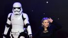 File shot from  December  2015 shows US actor Carrie Fisher  posing with a Star Wars stormtrooper as she attends the opening of the European Premiere of Star Wars: The Force Awakens in  London. The original Star Wars movie gave her her most high-profile role, as Princess Leia. File photograph: Leon Neal/AFP/Getty Images