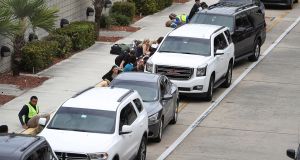  People take cover behind cars outside  Terminal 2 of Fort Lauderdale-Hollywood International airport after a shooting near the baggage claim on January 6, 2017 in Fort Lauderdale, Florida. Photograph: Joe Raedle/Getty Images