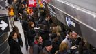 Commuters on a platform of a subway in New York this week. Photograph: John Taggart/The New York Times