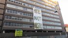 Occupiers of Apollo House unfurl a banner reading ‘Homes not hostels’ on Wednesday morning. Photograph: Dean Ruxton