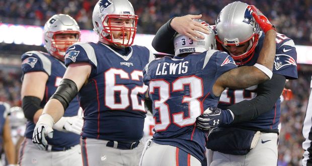 New England Patriots quarterback Tom Brady and running back Dion Lewis celebrate Lewis’ rushing touchdown in the fourth quarter of the NFL American football AFC divisional playoff at Gillette Stadium. Photograph: EPA