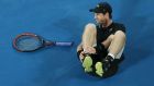 Andy Murray holds his ankle after he fell over in his second round match against Andrey Rublev of Russia on day three of the 2017 Australian Open. Photo: Scott Barbour/Getty Images