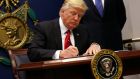 US president Donald Trump signs an executive order to impose tighter vetting of travellers entering the United States on Friday in Washington. Photograph: Reuters