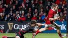 Munster’s Andrew Conway on his way to scoring a try despite the  tackle from Dorian Jones of Dragons during the Guinness Pro 12 game at Musgrave Park. Photograph: Tommy Dickson/Inpho