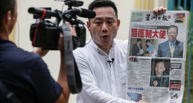 A reporter holds a newspaper featuring a story on North Korea’s ambassador to Malaysia, Kang Chol, in front of North Korea’s embassy in Kuala Lumpur. Photograph: Fazry Ismail/EPA