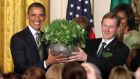 Former US president Barack Obama receives his bowl of shamrock from Taoiseach Enda Kenny  during a St Patrick’s Day reception  in 2012. Photograph: Chris Kleponis/Reuters