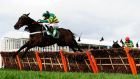Buveur D’Air, ridden by Noel Fehily, jumps the last before going on to win the Stan     James Champion Hurdle at Cheltenham on Tuesday. Photograph:  Harry Trump/Getty Images
