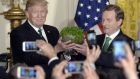  President Donald  Trump accepts a bowl of shamrock from  Taoiseach Enda Kenny  during a reception in the East Room of the White House, March 16th, 2017 in Washington, DC. Photograph: Olivier Douliery-Pool/Getty Images