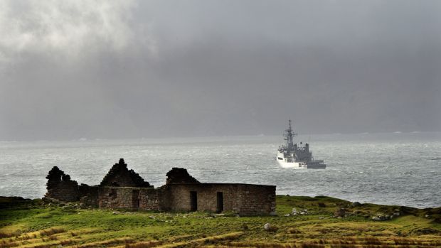 Irish Coast Guard helicopter crash: a naval vessel searches for the missing crew of Rescue 116. Photograph: Dara Mac Dónaill