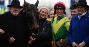 Jockey Robbie Power and trainer Jessica Harrington (right) with Sizing John after his victory in the  Gold Cup at  Cheltenham. Photograph: Harry Trump/Getty Images