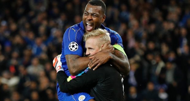 Leicester City’s Wes Morgan celebrates with Kasper Schmeichel after the goalkeeper’s penalty save against Sevilla in the Champions League last-16 game this week. Photograph:  Darren Staples/Reuters 