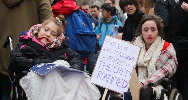 Bronwen O’ Reilly,  Glasnevin and Trinity student Niamh Herbert,  Kildare during a Dáil protest demanding ratification of the UN Convention of the Rights of Persons with Disabilities. Photograph: Gareth Chaney Collins