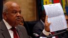 “Complete nonsense”: Former finance minister Pravin Gordhan with the intelligence report  president Jacob Zuma used to justify firing him. Photograph: Siphiwe Sibeko/Reuters