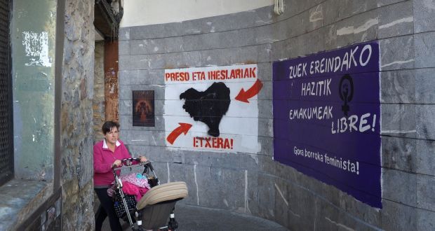 A woman walks past graffiti in favour of imprisoned armed Basque group Eta members in Hernani, Spain. Photograph: Vincent West/Reuters