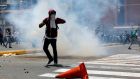 Demonstrators clash with security forces during an opposition rally in Caracas, Venezuela, on Tuesday. Photograph:  Carlos Garcia Rawlins/Reuters
