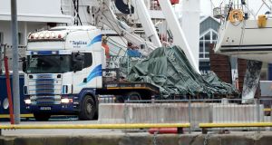The wreckage of the Irish Coast Guard helicopter leaves Galway harbour on a flat bed truck. Photograph: Brian Lawless/PA Wire