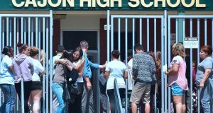 A student and her mother embrace  upon leaving Cajon High School in San Bernardino, California, where  children from nearby North Park Elementary School had been brought after a shooting.  Photograph: Frederic J Brown/AFP/Getty Images