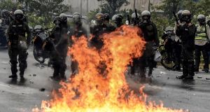 Venezuelan national guard personnel in riot gear and opposition activists clash in Caracas on April 13th, 2017. Photograph: Juan  Barreto/AFP/Getty Images