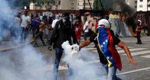 Opposition demonstrators clash with riot police during the  “mother of all marches” against Venezuela’s President Nicolas Maduro in Caracas on Wednesday. Photograph: Marco Bello/Reuters