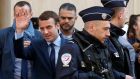Emmanuel Macron leaves his home surrounded by policemen in Paris on Monday, after the first round of presidential elections where he ended in first place. Photograph:  Benoit Tessier/Reuters
