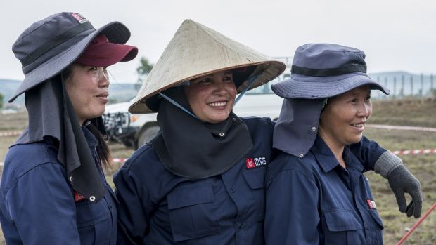 Staff from Mines Advisory Group (MAG) at the end of a long day demining a rice field in Phonsavan, northeast Laos. Photograph: Brenda Fitzsimons