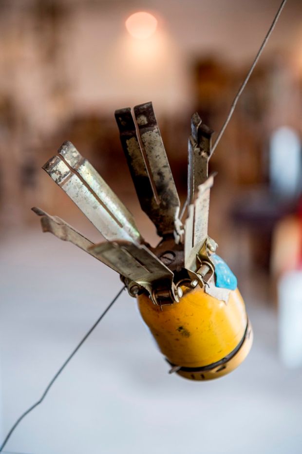 A Pineapple bomb on display at the Cope Visitor Centre in Vientiane, Laos. Cope was formed in 1997 and created in response to the need to provide UXO (unexploded ordnance) survivors with the care and support they require, namely by way of orthotic and prosthetic devices which are made on site at the centre. Photograph: Brenda Fitzsimons