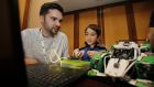   CoderDojo Co-Founder James Whelton and 9-year-old coder Michael Comiskey: Beginning with one club in Cork in 2011, the open-access programming movement has grown to become a global network of 1,250 clubs across almost 70 countries. Photograph:  Nick Bradshaw