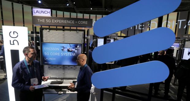 Ericsson employees stand inside their booth at Mobile World Congress. 