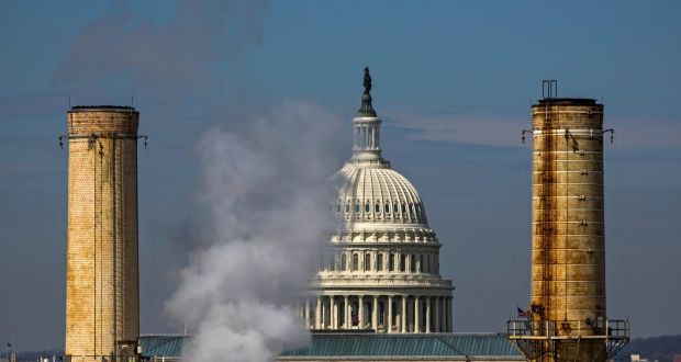 The dome of the US Capitol is seen behind the smokestacks of the only coal-burning power plant in Washington, DC. Photograph: Jim Lo Scalzo/EPA
