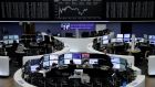Traders work in front of the German share price index in Frankfurt, Germany. Photograph: Reuters