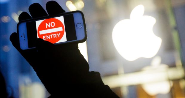  February 2016:  a man holds up an iPhone displaying a “No Entry” image as part of a rally in front of an Apple store in New York in support of the company’s privacy policy. Photograph: Justin Lane/EPA