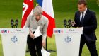Strong and stable? Theresa May’s notes try to escape during her joint statement with Emmanuel Macron at the Élysée Palace in Paris. (Photograph: Reuters/Philippe Wojazer)