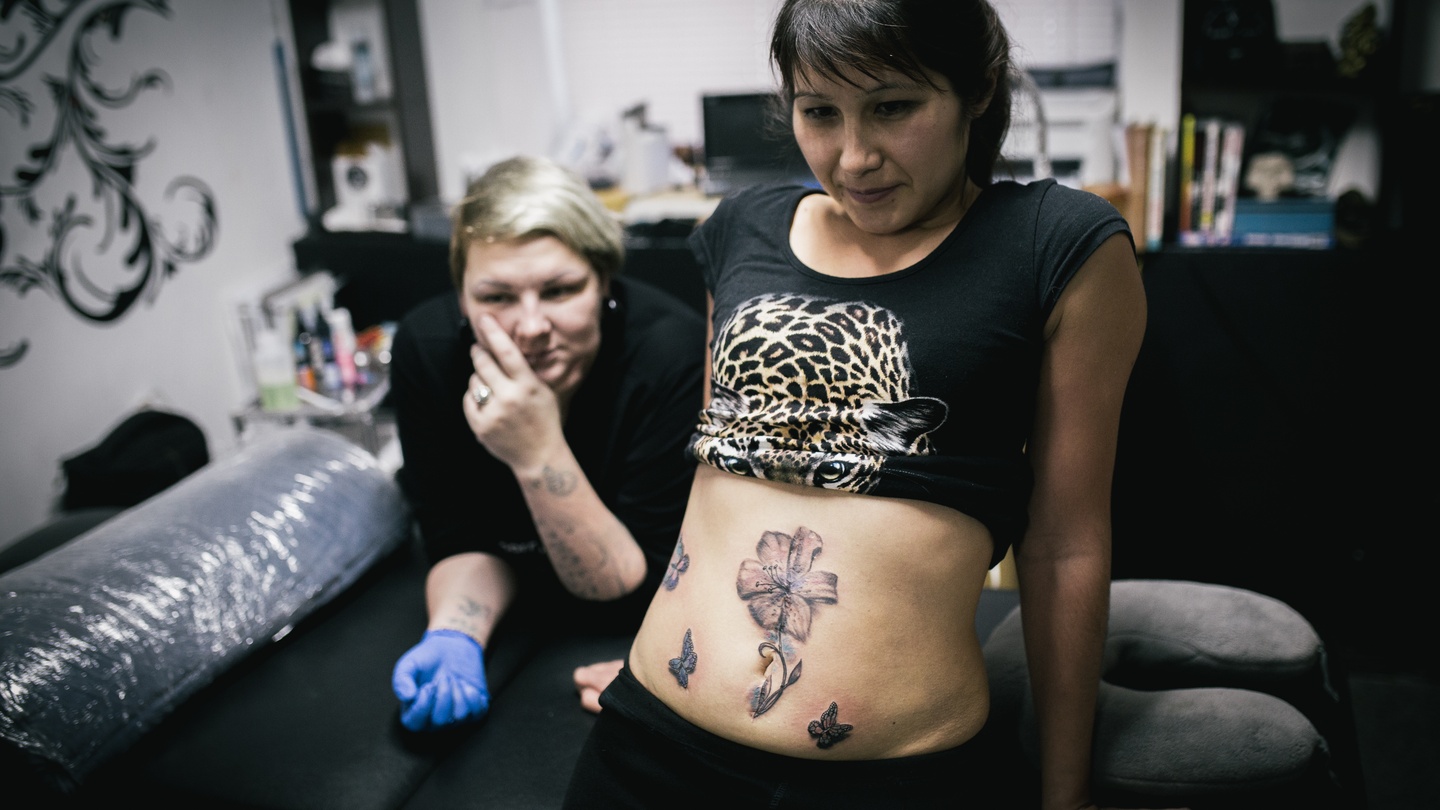 Tattooing over the scars of domestic violence.