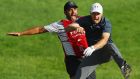 Jordan Spieth of the United States celebrates with caddie Michael Greller after chipping in for birdie from a bunker on the 18th green to win the Travelers Championship in a playoff against Daniel Berger. Photo: Maddie Meyer/Getty Images