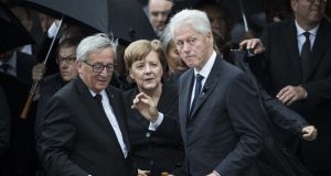  Former US president Bill Clinton, President of the European Commission Jean-Claude Juncker and German Chancellor Angela Merkel talk as they pay respect to late former chancellor Helmut Kohl at the cathedral in Speyer, Germany. Photograph: Maja Hitij/Getty Images