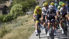 Chris Froome, wearing the overall leader’s yellow jersey, rides in the pack next to Michal Kwiatkowski and Germany’s Simon Geschke during the 16th stage of the Tour de France. Photo: Lionel Bonaventure/Getty Images