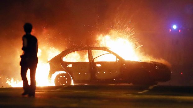 A car on fire in the North Queen Street area of Belfast, close to the site of a contentious bonfire. A refusal to tackle dangerous loyalist bonfires has undermined faith in the rule of law. Photograph: Niall Carson/PA Wire