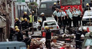 Royal Ulster Constabulary police officers and firefighters inspecting the damage caused by a bomb explosion in Market Street, Omagh, Co Tyrone, on August 15th 1998. File photograph: Paul McErlane/PA 